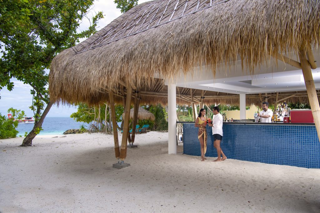 Strandbar Sunrise Cafe mit blau gekachelten Elementen und Bambuspfeilern am Strand