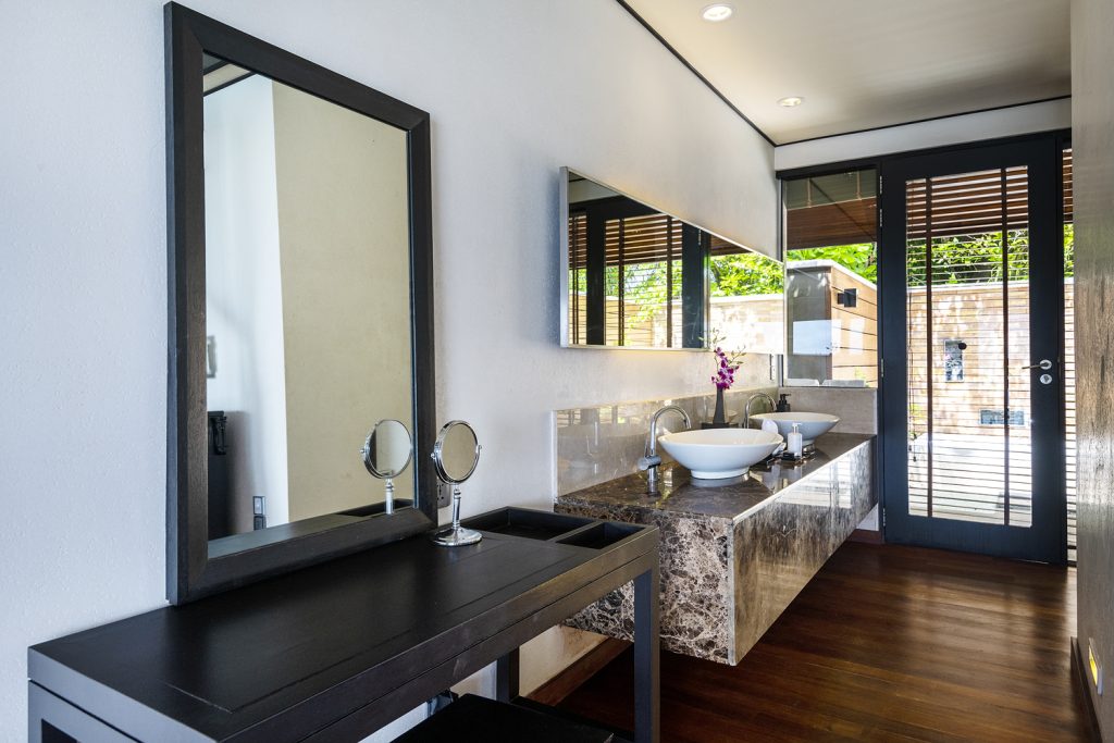 Modernes Badezimmer der Lagoon Villa im Lily Beach Resort & Spa mit zwei Waschbecken, Marmorarbeitsplatte und großem.