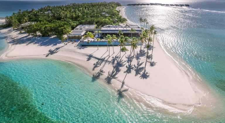 Luftaufnahme des Alila Kothaifaru Maldives Resorts mit weißem Sandstrand, türkisfarbenem Wasser und grünem Dschungel.